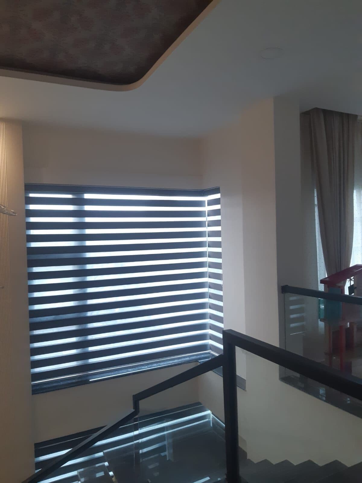 Zebra blinds over a staircase landing