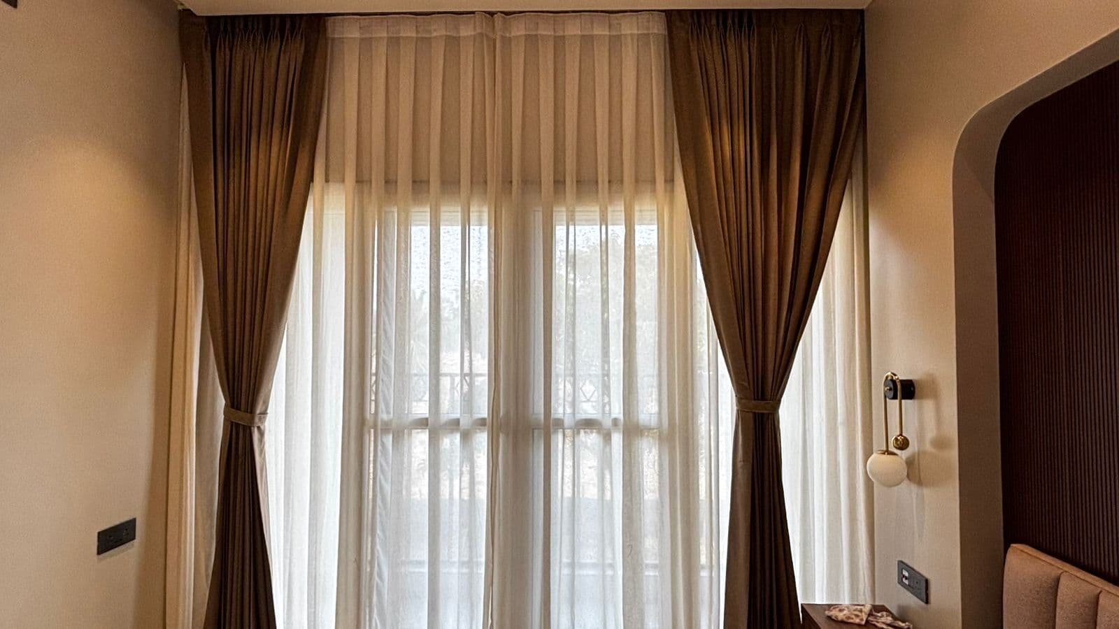 Sheer and drape layers in a bedroom