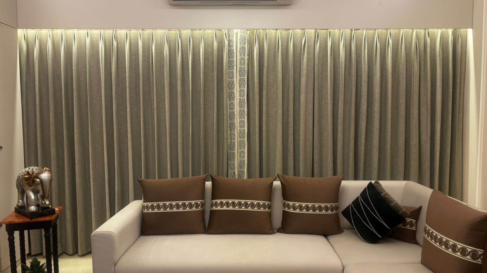 Pleated drapes across a living room in Jorhat
